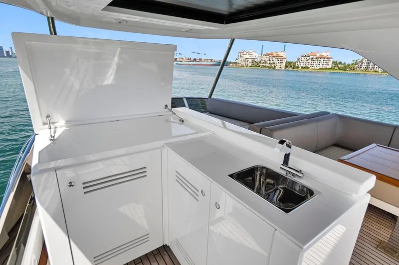 Smile Yacht Photos Pics 2023 Astondoa 66 Flybridge yacht with outdoor kitchenette and scenic ocean view.