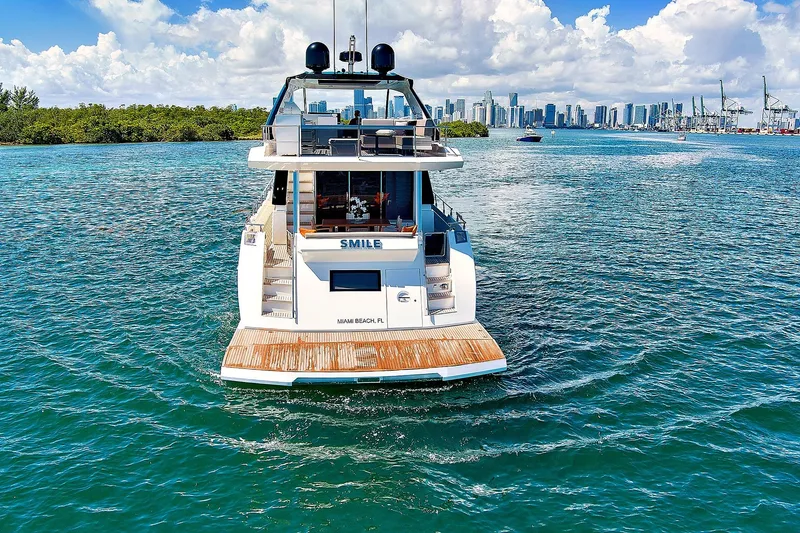 Smile Yacht Photos Pics 2023 Astondoa 66 Flybridge yacht cruising near Miami skyline on a sunny day.