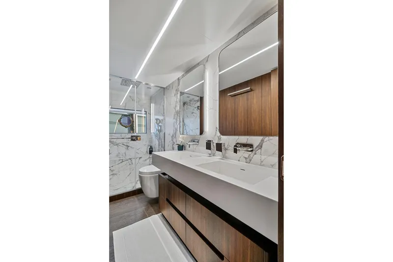 Smile Yacht Photos Pics Luxurious bathroom in 2023 Astondoa 66 Flybridge yacht with marble and wood finishes.