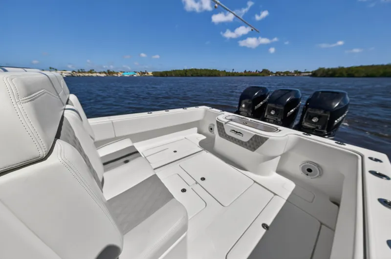  Yacht Photos Pics Invincible 36 Open Fisherman 2023 on calm water with three outboard engines.