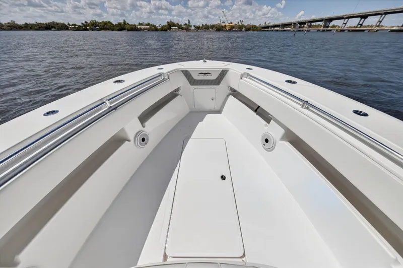  Yacht Photos Pics Invincible 36 Open Fisherman 2023 on calm water with bridge in background.