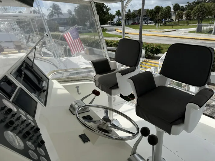  Yacht Photos Pics 1996 Viking 50 Convertible yacht helm with dual captain chairs and steering wheel.