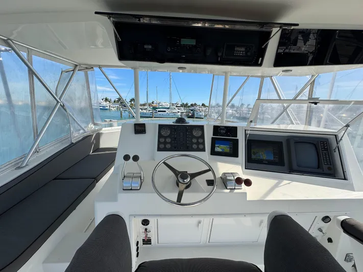  Yacht Photos Pics Interior helm of 1996 Viking 50 Convertible yacht with steering wheel and navigation equipment.