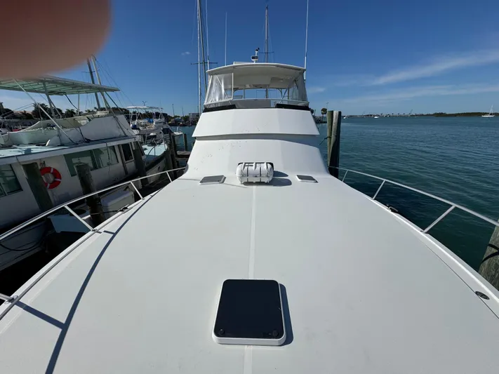  Yacht Photos Pics Viking 50 Convertible 1996 yacht docked at marina, clear blue sky.