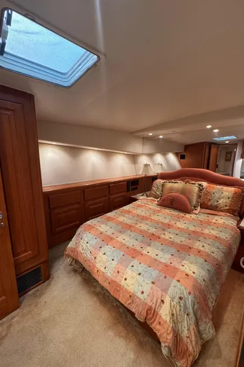  Yacht Photos Pics Cozy bedroom in 1996 Viking 50 Convertible yacht with skylight and wood cabinetry.