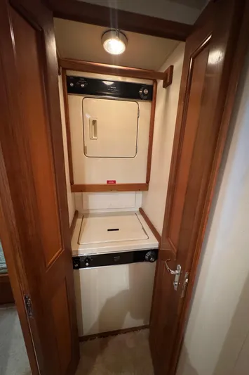  Yacht Photos Pics Laundry area in 1996 Viking 50 Convertible yacht with stacked washer and dryer.