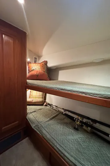  Yacht Photos Pics 1996 Viking 50 Convertible cabin with bunk beds and fishing rods.