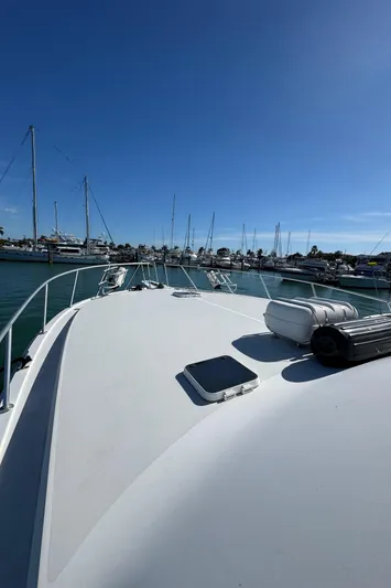  Yacht Photos Pics 1996 Viking 50 Convertible yacht docked in a marina under clear blue skies.