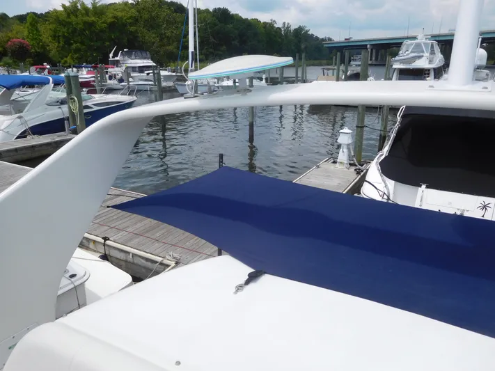  Yacht Photos Pics 2006 Carver 36 Mariner docked at marina with blue canopy.