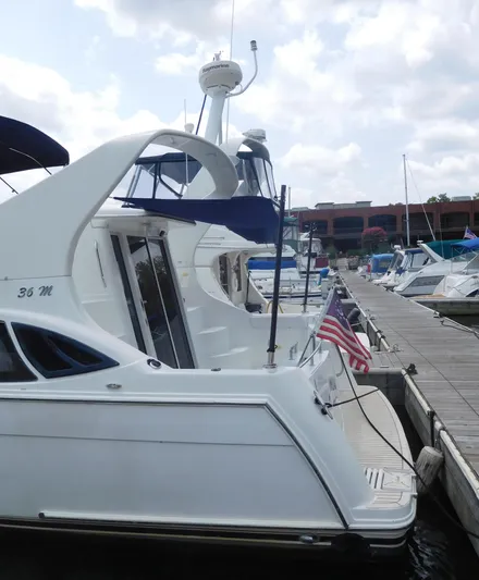  Yacht Photos Pics 2006 Carver 36 Mariner yacht docked at marina with American flag.