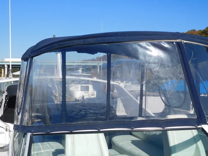  Yacht Photos Pics 2006 Carver 36 Mariner boat with clear canopy and seating area.