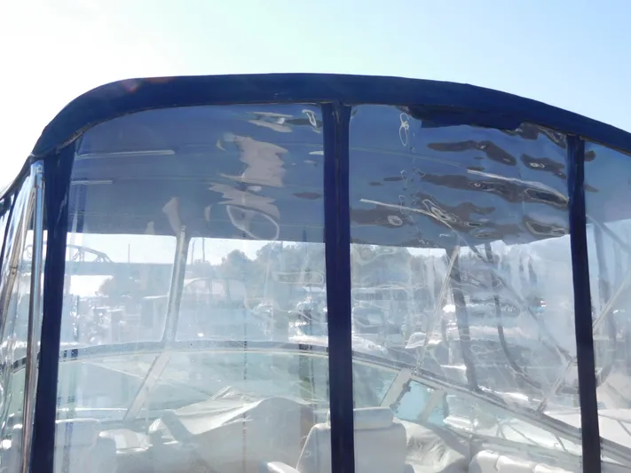  Yacht Photos Pics 2006 Carver 36 Mariner boat with clear enclosure and blue trim.