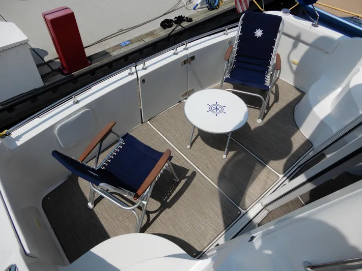  Yacht Photos Pics 2006 Carver 36 Mariner deck with chairs and nautical-themed table.