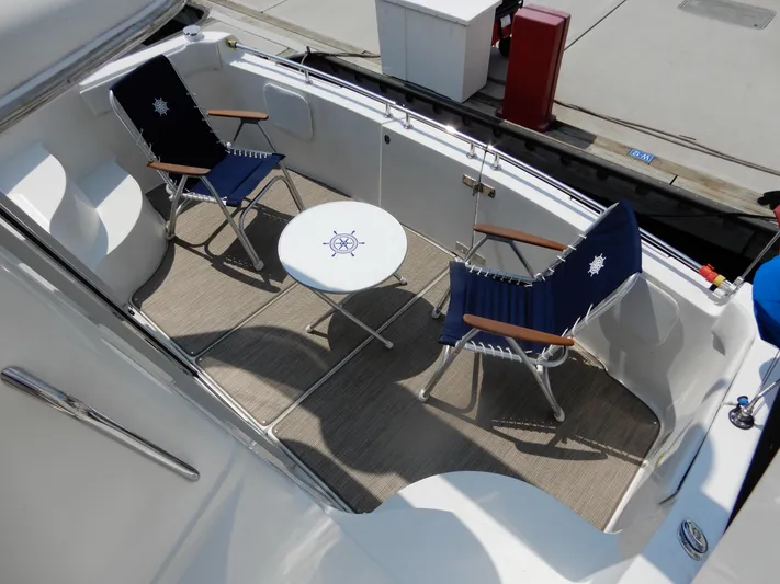  Yacht Photos Pics 2006 Carver 36 Mariner deck with chairs and nautical-themed table.