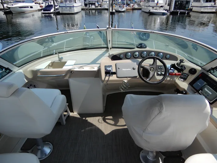  Yacht Photos Pics 2006 Carver 36 Mariner helm with modern navigation equipment and comfortable seating at marina.