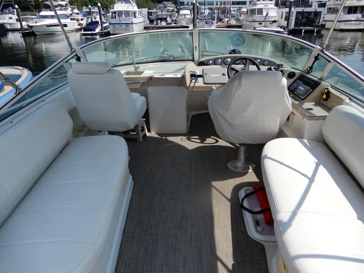  Yacht Photos Pics 2006 Carver 36 Mariner yacht interior with white seating and helm, docked at marina.