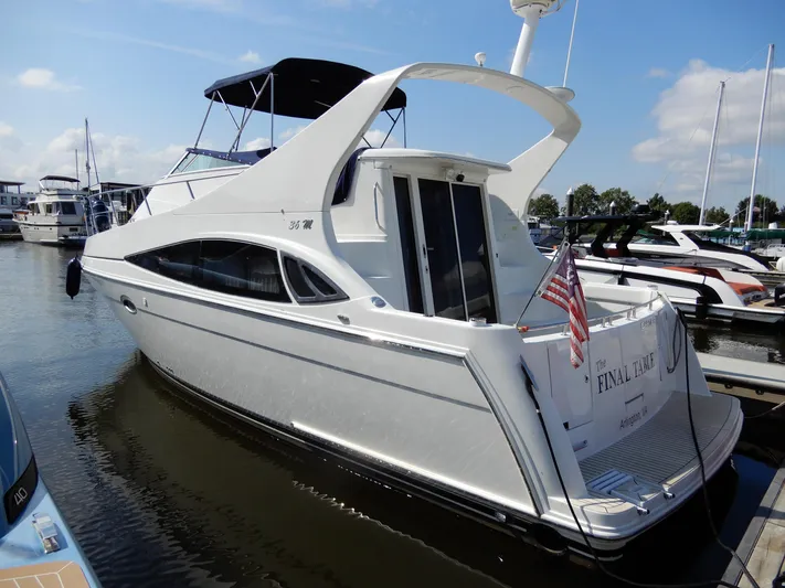  Yacht Photos Pics 2006 Carver 36 Mariner yacht docked at marina, featuring sleek design and American flag.