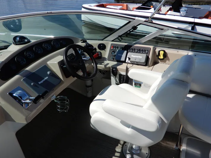  Yacht Photos Pics 2006 Carver 36 Mariner helm with Raymarine controls and white captain's chair.