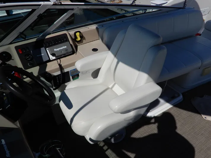  Yacht Photos Pics Captain's seat and dashboard of 2006 Carver 36 Mariner boat with Raymarine equipment.