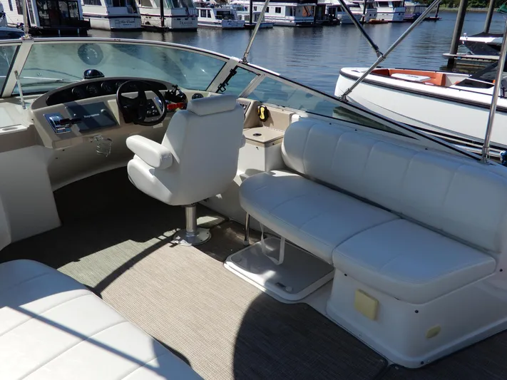  Yacht Photos Pics 2006 Carver 36 Mariner boat interior with white seating and steering wheel, docked at marina.