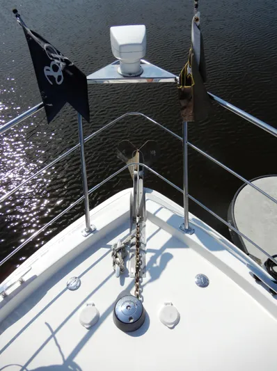 Yacht Photos Pics Bow of 2006 Carver 36 Mariner with anchor chain and flags on calm water.