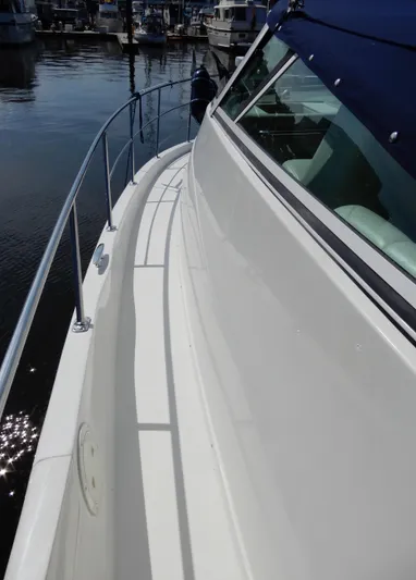  Yacht Photos Pics 2006 Carver 36 Mariner yacht docked, showcasing sleek white deck and railing.