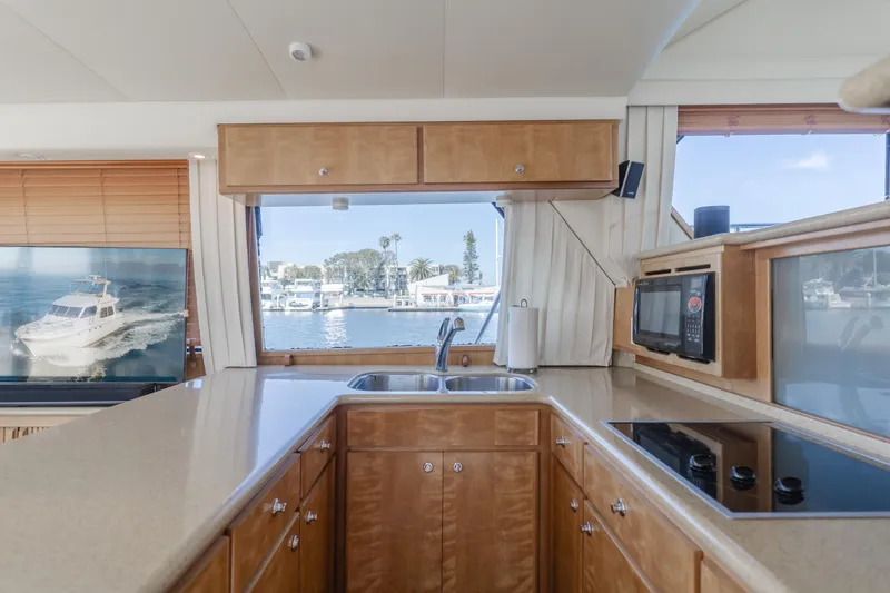 Love Life Yacht Photos Pics 2007 Navigator Pilothouse kitchen with modern appliances and marina view.