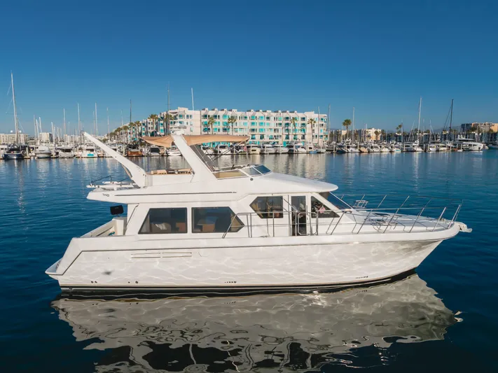 Love Life Yacht Photos Pics 2007 Navigator Pilothouse yacht docked in a marina with clear blue skies.