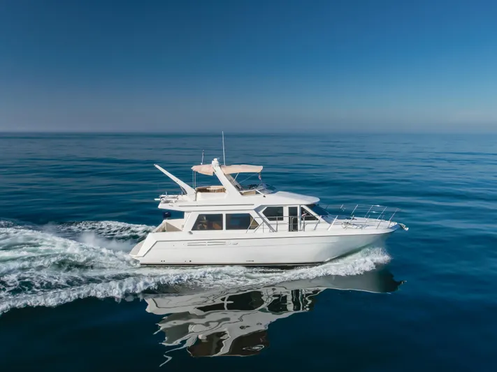 Love Life Yacht Photos Pics 2007 Navigator Pilothouse yacht cruising on calm ocean waters.