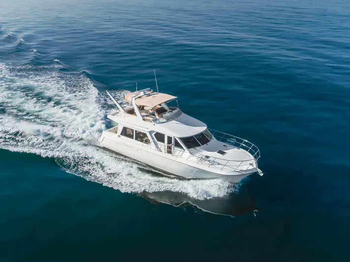 Love Life Yacht Photos Pics 2007 Navigator Pilothouse yacht cruising on calm blue waters.