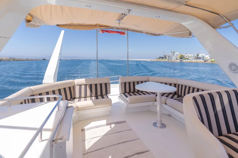 Love Life Yacht Photos Pics Luxurious 2007 Navigator Pilothouse yacht with elegant seating, ocean view, and sunny weather.