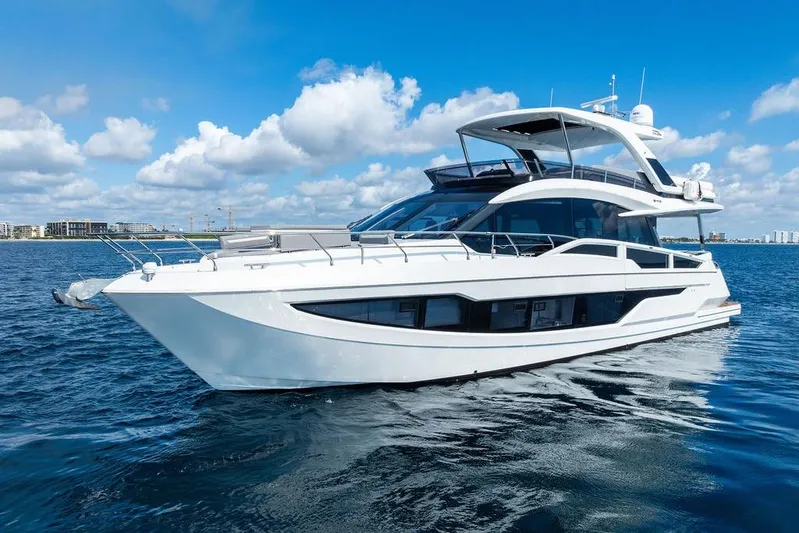 Triple T Yacht Photos Pics 2022 Galeon 640 Fly yacht cruising on open water under a clear blue sky.