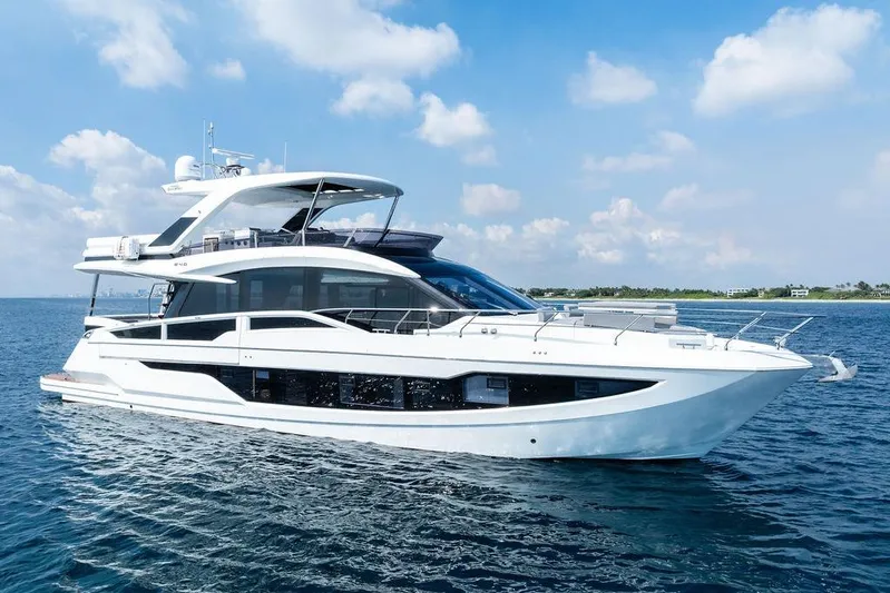Triple T Yacht Photos Pics Luxury 2022 Galeon 640 Fly yacht cruising on open water under blue skies.