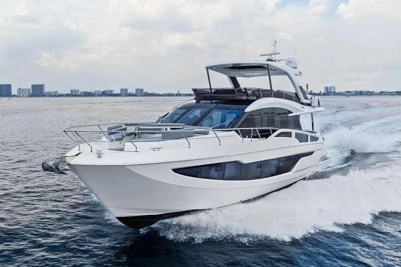 Triple T Yacht Photos Pics 2022 Galeon 640 Fly yacht cruising on open water, showcasing sleek design and luxury.