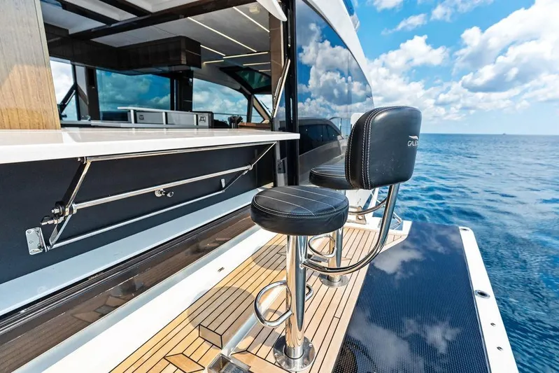 Triple T Yacht Photos Pics Luxury Galeon 640 Fly yacht deck with bar stools, ocean view, 2022 model.