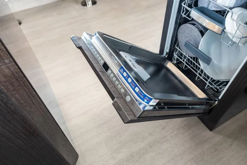 Triple T Yacht Photos Pics Open dishwasher in Galeon 640 Fly yacht, showcasing modern kitchen amenities, 2022 model.