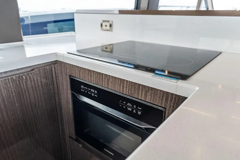 Triple T Yacht Photos Pics Modern kitchen area in 2022 Galeon 640 Fly yacht with stovetop and oven.