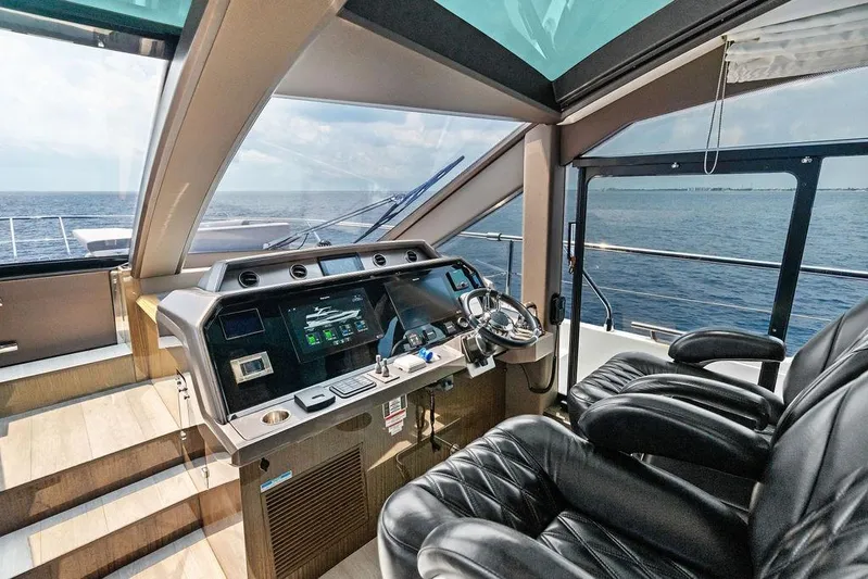 Triple T Yacht Photos Pics Luxurious 2022 Galeon 640 Fly yacht cockpit with modern controls and ocean view.