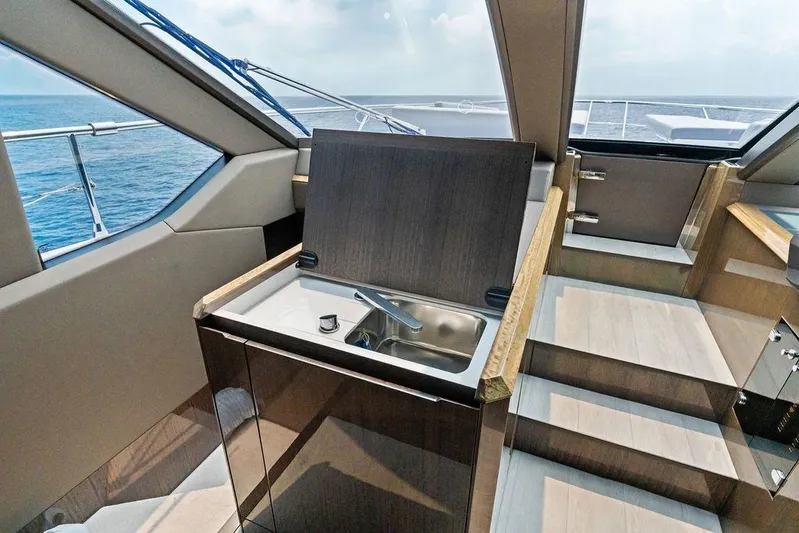 Triple T Yacht Photos Pics Luxurious interior of 2022 Galeon 640 Fly yacht with modern kitchenette and ocean view.
