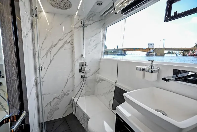 Triple T Yacht Photos Pics Luxurious bathroom on 2022 Galeon 640 Fly yacht with marble design and scenic window view.