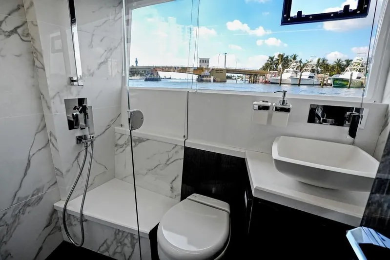 Triple T Yacht Photos Pics Luxurious bathroom on 2022 Galeon 640 Fly yacht with marble accents and ocean view.