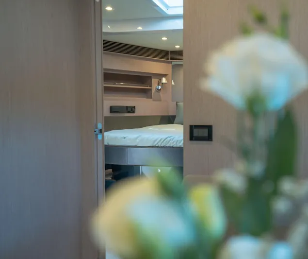  Yacht Photos Pics Luxurious interior of 2015 Riva 63 Virtus yacht, featuring a cozy bedroom.