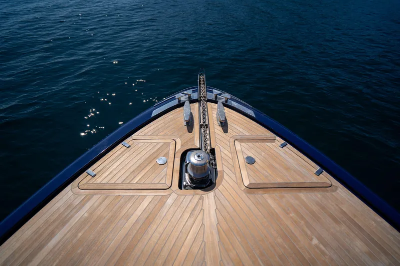  Yacht Photos Pics Bow of 2015 Riva 63 Virtus yacht with teak deck on calm water.