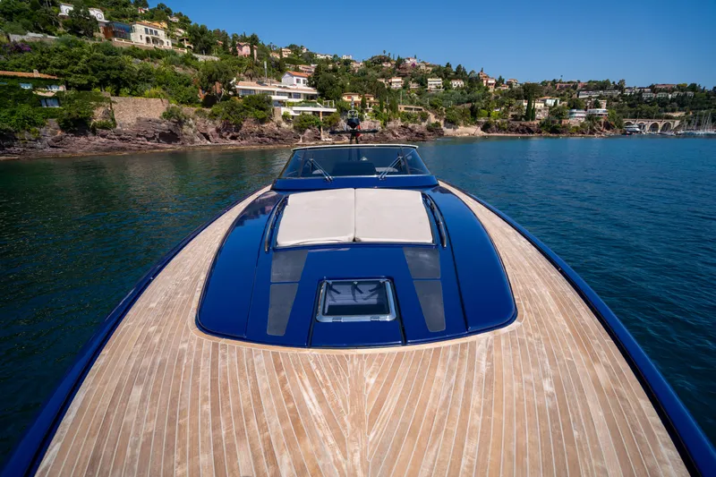  Yacht Photos Pics 2015 Riva 63 Virtus yacht on serene water with scenic coastal backdrop.