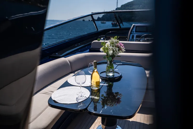  Yacht Photos Pics Luxurious 2015 Riva 63 Virtus yacht interior with elegant table setting and ocean view.