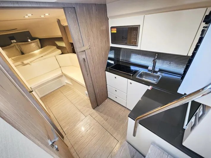  Yacht Photos Pics Interior of 2024 Sessa Marine C36 OB yacht, featuring modern kitchen and cozy seating area.