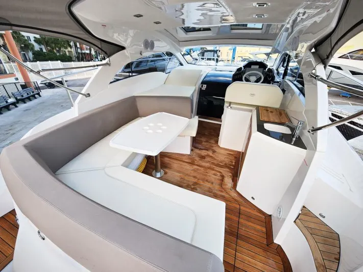  Yacht Photos Pics Luxurious interior of 2024 Sessa Marine C36 OB yacht with elegant seating and wooden flooring.
