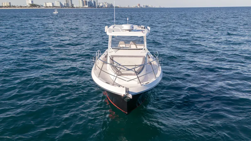  Yacht Photos Pics 2025 SeaWell 290XL boat on open water with city skyline in background.