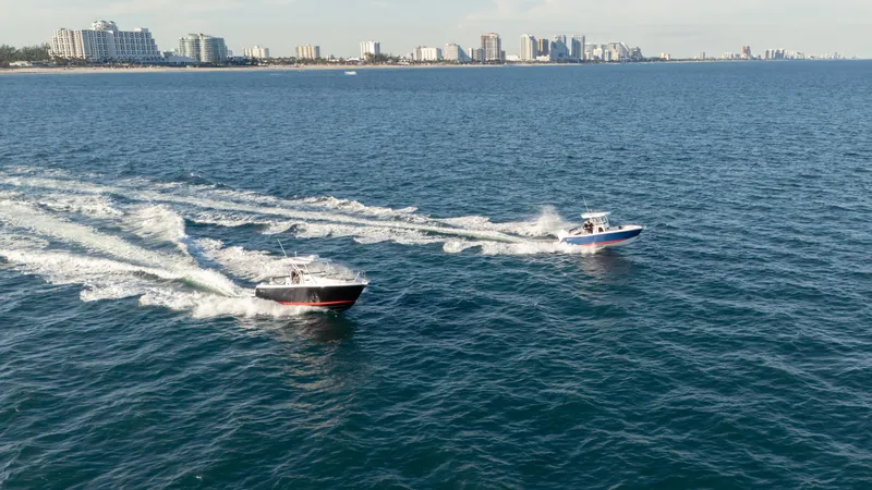  Yacht Photos Pics Two SeaWell 290XL boats cruising on the ocean near a city skyline, 2025 model.