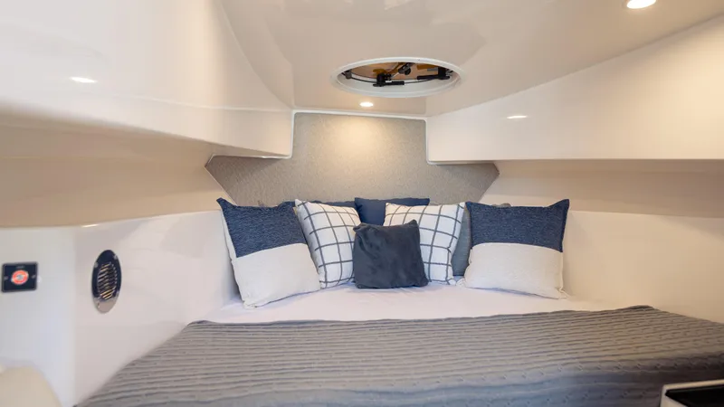  Yacht Photos Pics Cozy cabin interior of 2025 SeaWell 290XL boat with stylish pillows and modern design.